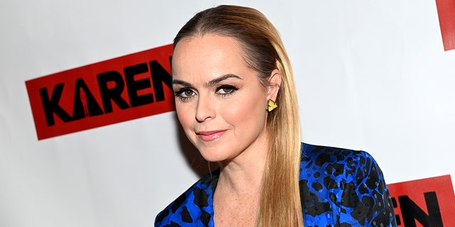 Taryn Manning in an electric blue and black dress oft smiles on the carpet for "Karen"