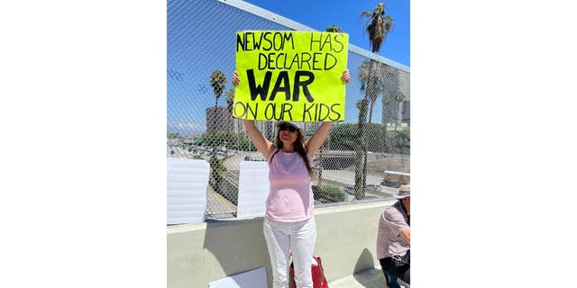 Woman holds up sign in LA protest
