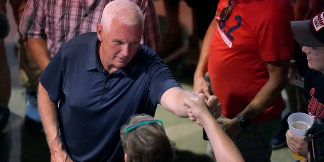 Republican presidential candidate Mike Pence shakes a voter's hand in Iowa