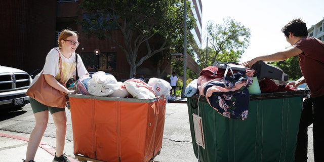 Students pushing carts on college move-in day