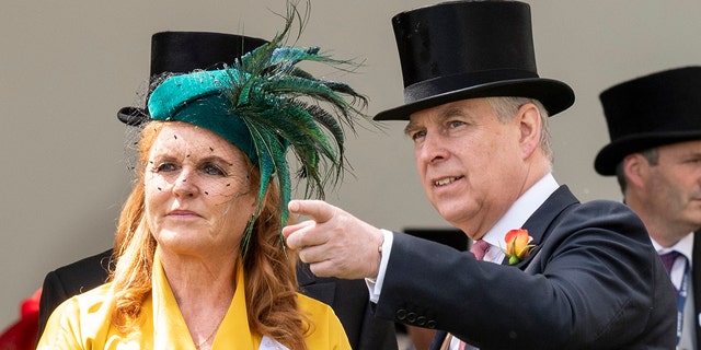 Sarah Ferguson wearing a yellow dress and a green hat standing next to Prince Andrew in a suit and top hat