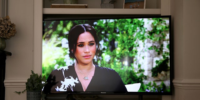 A close-up of Meghan Markle on television talking to Oprah Winfrey