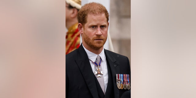 A close-up of Prince Harry in a morning suit looking somber