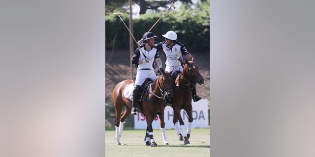 Prince Harry and Nacho Figueras on horses at a polo match