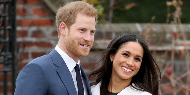 Prince Harry and Meghan Markle smile as senior royals