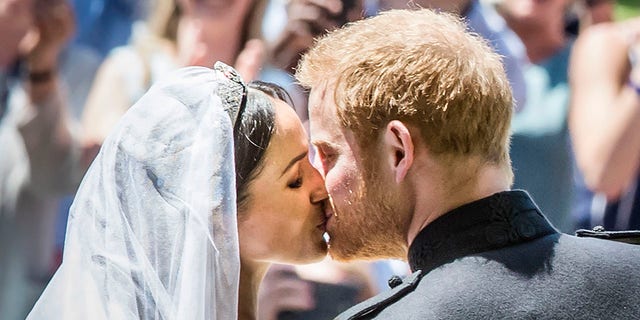 A photo of Prince Harry and Meghan Markle kissing after wedding