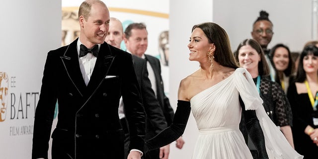 Prince William smiles after Kate Middleton pats his behind at BAFTAs