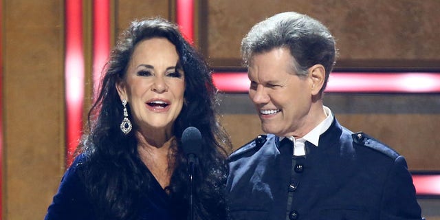Randy Travis and wife Mary on stage as Mary speaks