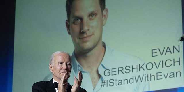 Photo of Evan Gershkovich on billboard behind President Biden