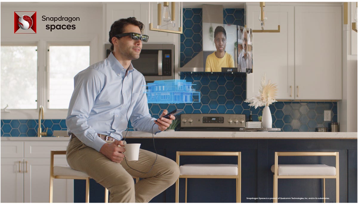 A man with AR glasses on, holding a phone, seeing a floating window with a person speaking to him