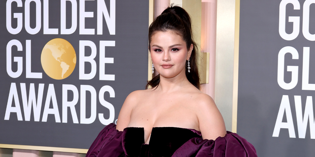 Selena Gomez in front of Golden Globes signage