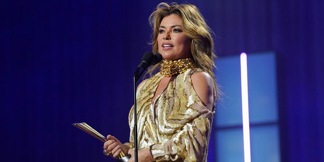 Shania Twain on stage at a microphone