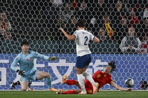 Chinese defender Yao Wei, right, blocks a shot from England's Lucy Bronze.