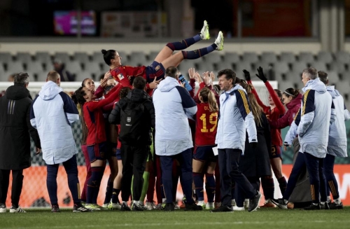 Spain's Jennifer Hermoso is thrown in the air by teammates as they celebrate their 5-0 victory over Zambia on July 26. With the win, Spain clinched a spot in the tournament's knockout round.