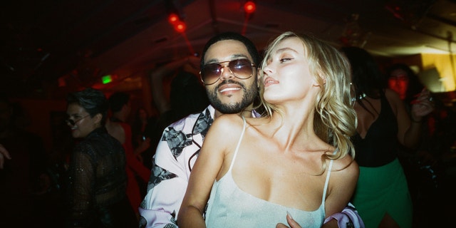 Abel "The Weeknd" Tesfaye and Lily-Rose Depp hugging in a scene from The Idol
