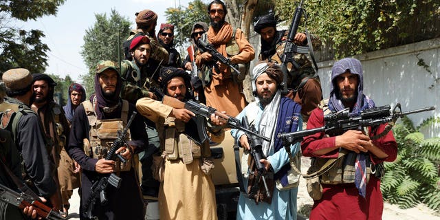 Armed Taliban fighters pose for a photograph