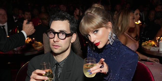 Jack Antonoff and Taylor Swift toast at the Grammys