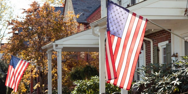 American flags flying outside homes