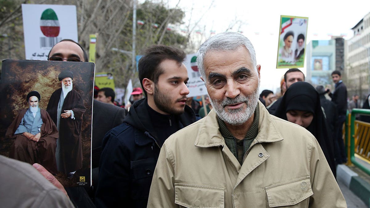 Soleimani walks with a crowd