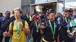 South African senior national women's team players Janine van Wyk (L), captain Refiloe Jane (C) and goalkeeper Andile Dlamini (R) react as they arrive at OR Tambo International Airport as they celebrate winning the 2022 Women's Africa Cup of Nations (WAFCON) in Kempton Park on July 26, 2022. - The team nicknamed Banyana Banyana (The Girls), won their first WAFCON on their sixth attempt after beating the host nation Morocco 2-1 at the Prince Moulay Abdellah Stadium in Rabat on Saturday, July 23. (Photo by Phill Magakoe / AFP) (Photo by PHILL MAGAKOE/AFP via Getty Images)