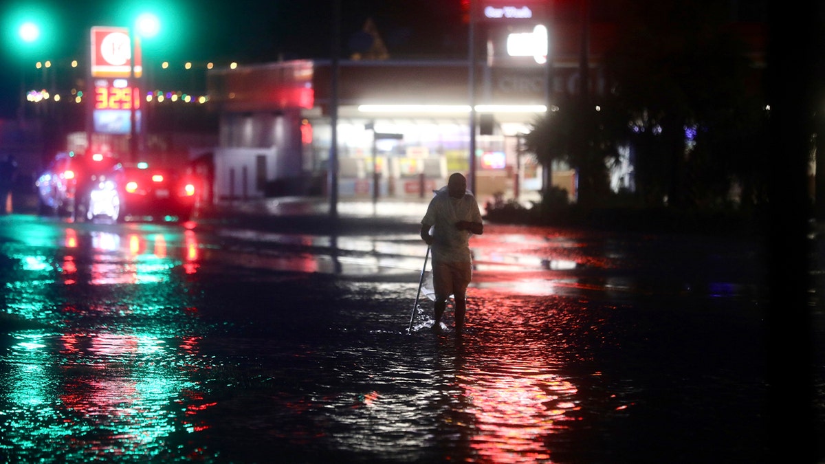 Man walks in South Carolina floodwaters