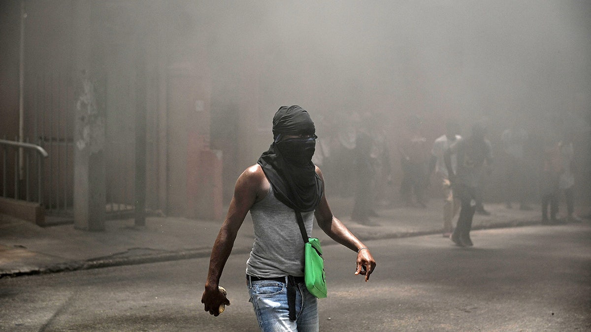 Smoke filled Haiti street amid demonstrations