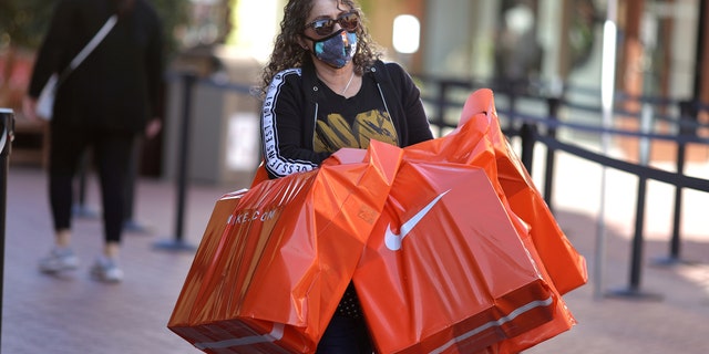 Woman carries bags out of Citadel Outlet mall