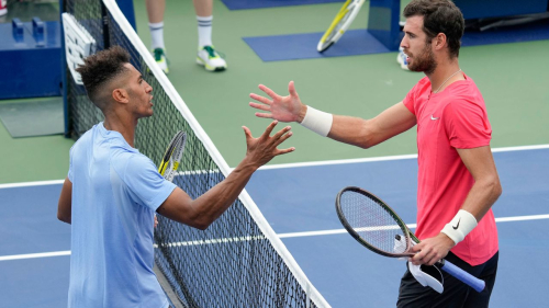 Michael Mmoh, of the United States, left, shakes hands with Karen Khachanov, of Russia, after defeating Khachanov during the first round of the U.S. Open tennis championships, Tuesday, Aug. 29, 2023, in New York. (AP Photo/John Minchillo)