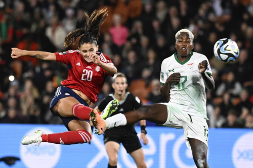 Costa Rica's Fabiola Villalobos, left, takes a shot at goal as Zambia's Racheal Kundananji attempts to block.