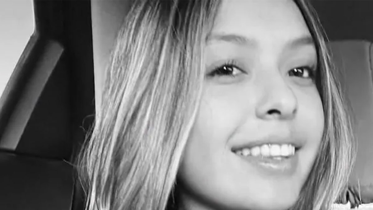 Jacqueline Nunez smiles in a black and white photo.