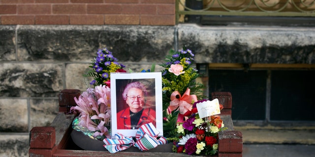 A photo of a portrait of Marion County Record co-owner Joan Meyer surrounded by flowers and ribbons
