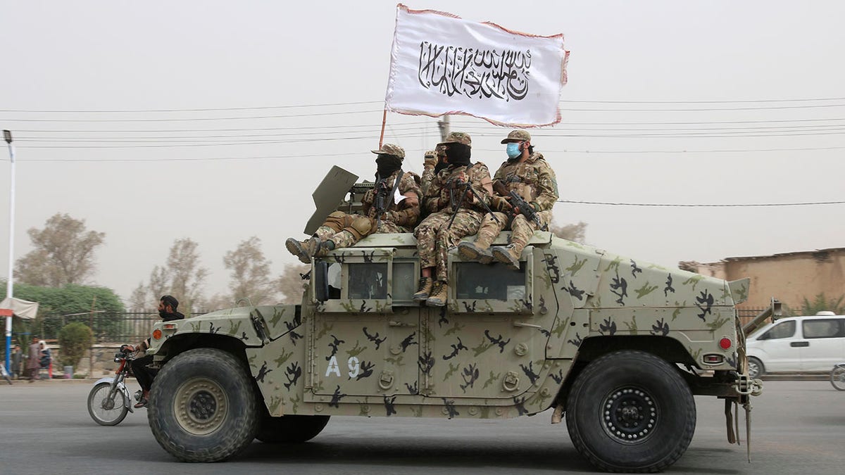 Taliban fighters on vehicle in Afghanistan