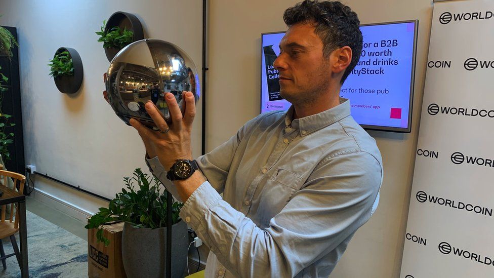The BBC's Cyber Correspondent Joe Tidy testing out a Worldcoin Orb