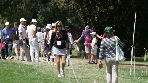 Markus Zechmann (left), caddie for US golfer Angel Yin, questions a young boy who picked up Yin's ball while it was still in play. A portion of this image has been blurred by CNN to protect identity.