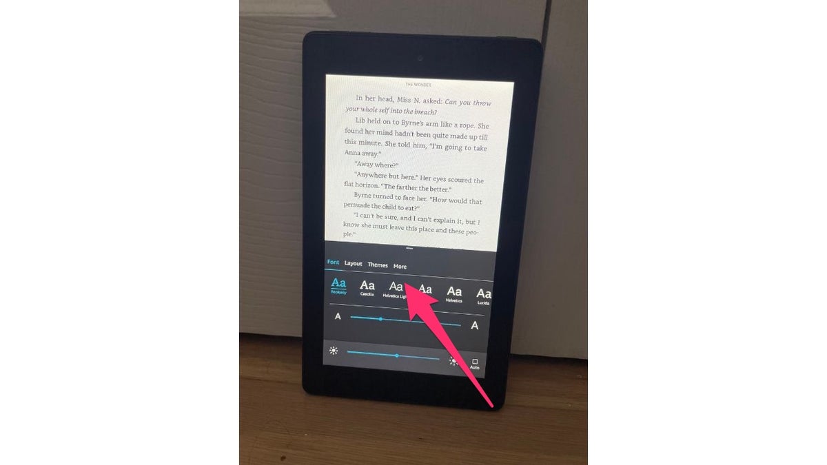 Red arrow pointing to the more icon on an Amazon Kindle