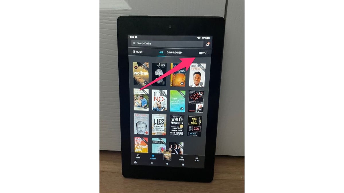 Red arrow pointing to the sort tab on the Amazon Kindle