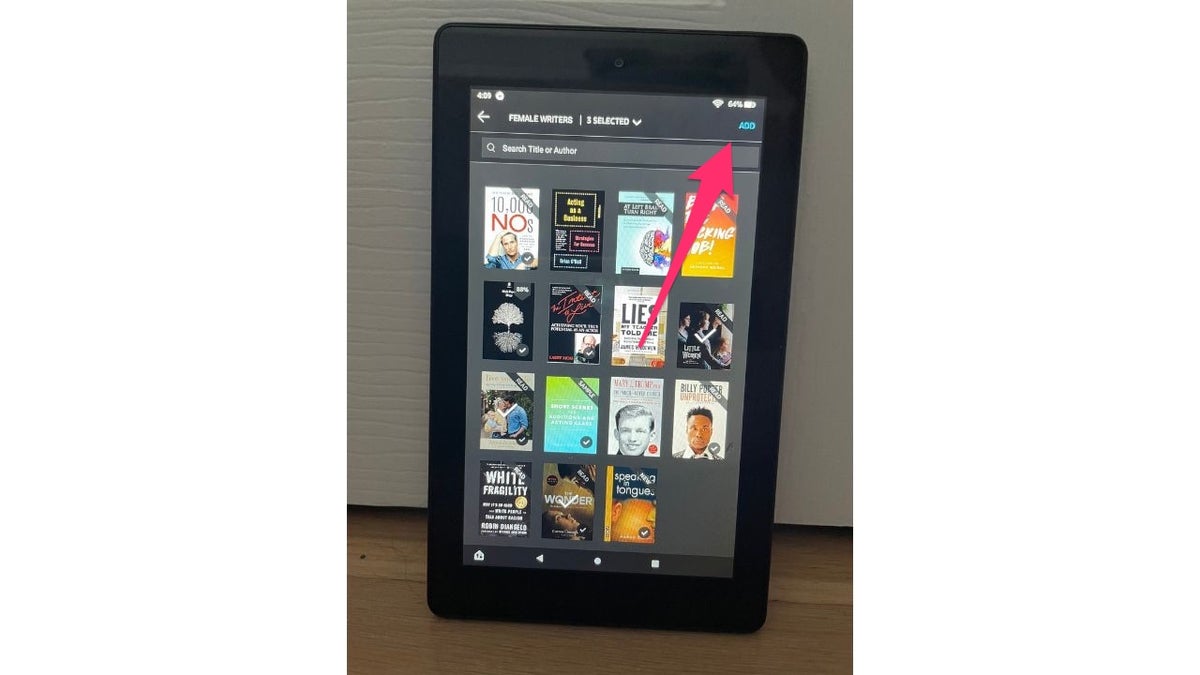 Red arrow pointing to the add option on Amazon Kindle after you chose which books you want in that collection