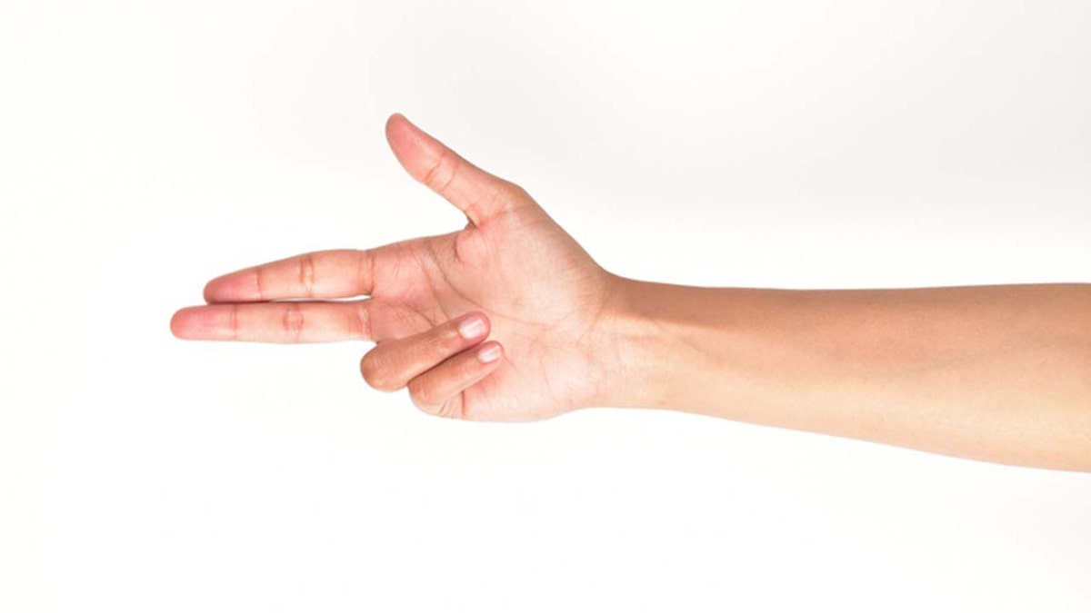 Someone makes a finger gun against a white background