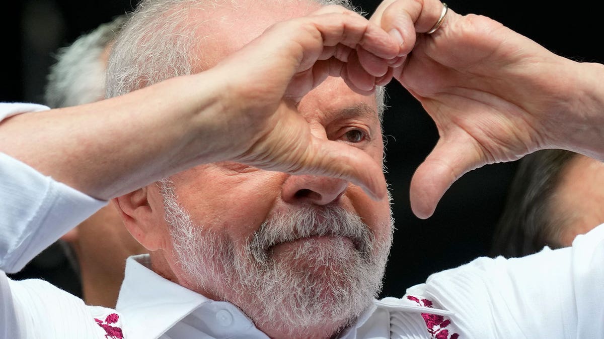 brazilian president makes heart shape with hands