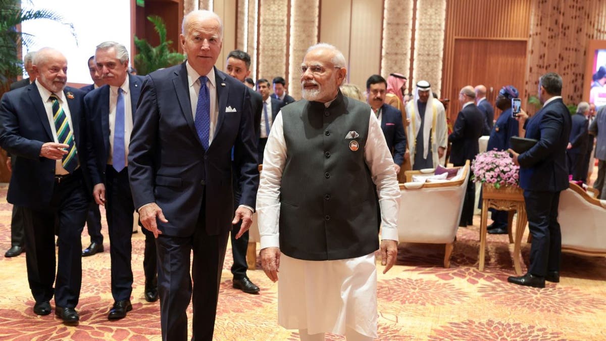 Biden and Modi walking