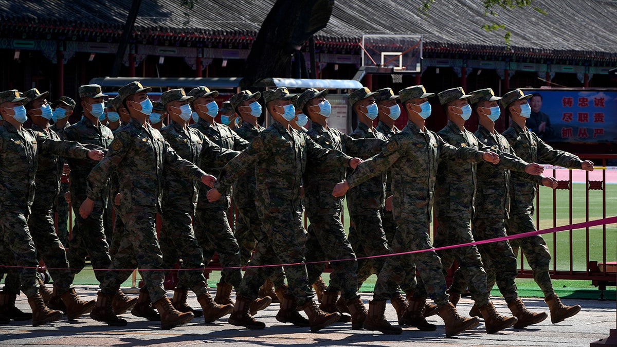 Chinese soldiers march during CCP ceremony
