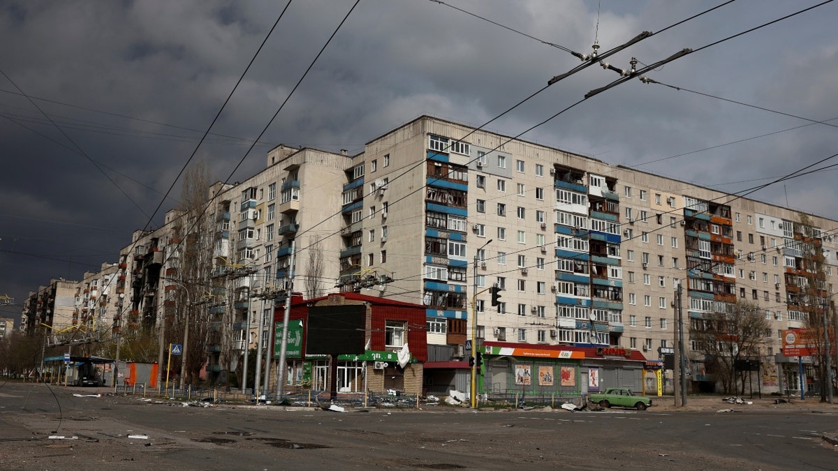 Ukrainian apartment building destroyed after military strike, clodu skies