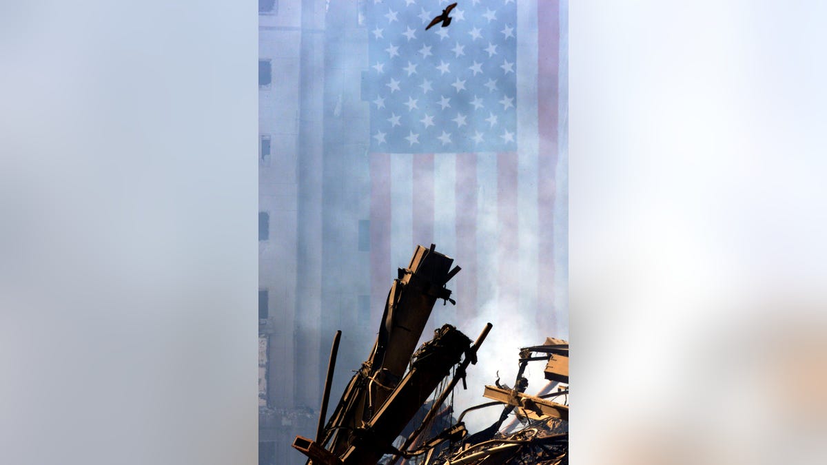 US flag in background with steel wreckage from WTC on Sept. 19, 2001