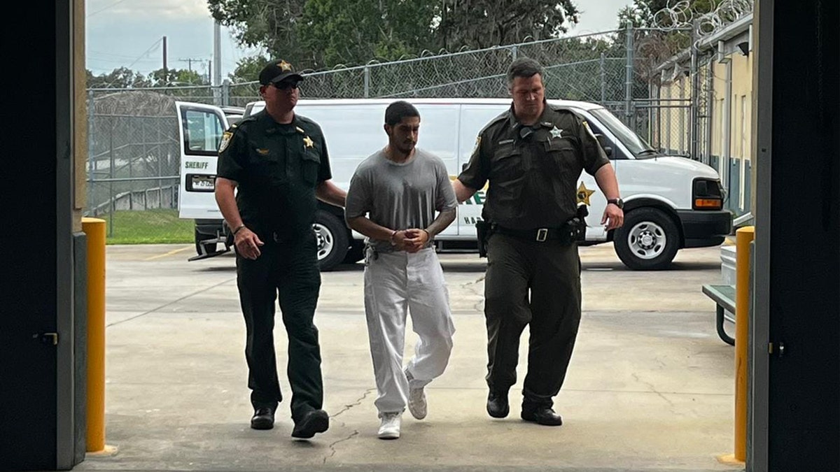 Mathew Flores escorted by Florida authorities