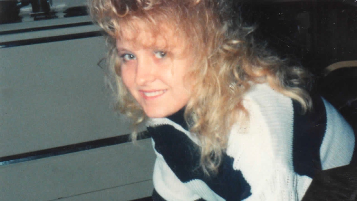 Carol Marlene Sullens wearing a black and white striped sweater with curly blonde hair