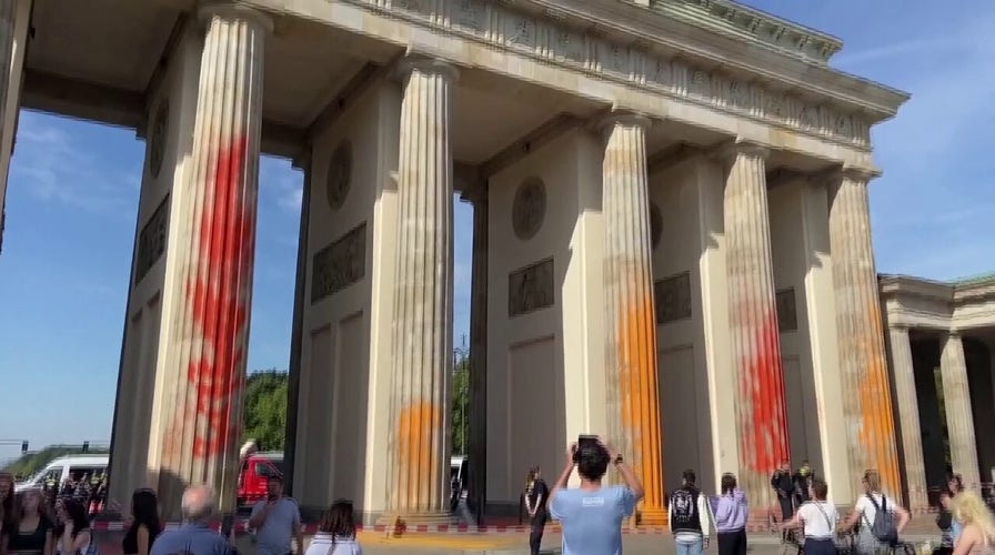 German climate activists spray paint Brandenburg Gate in Berlin