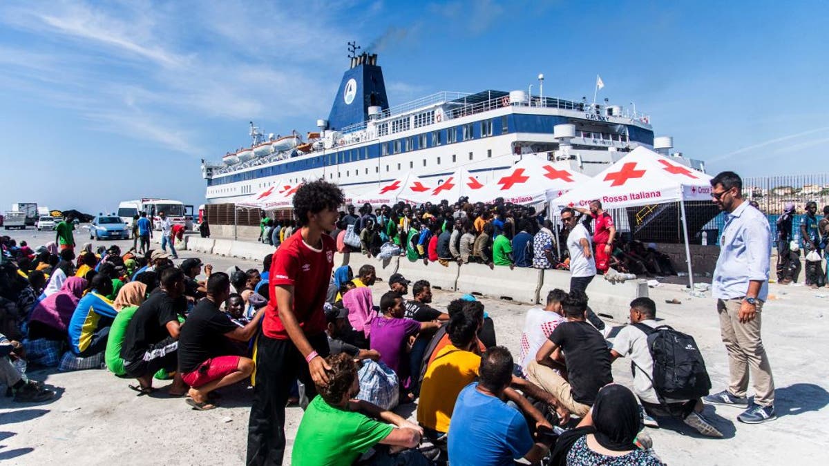 Migrants processing after arrival in Italy