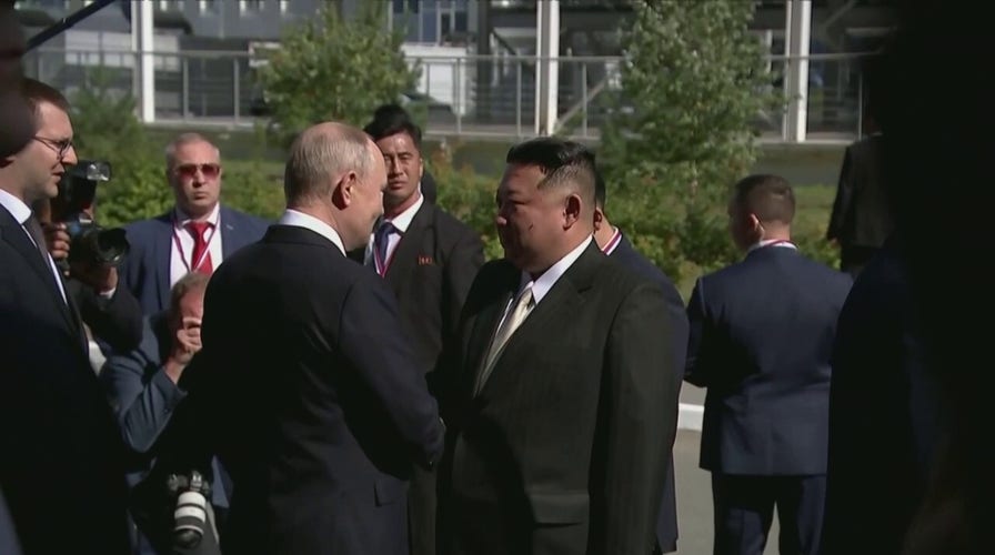 Vladimir Putin greets Kim Jong Un with handshake before planned meeting in Russia
