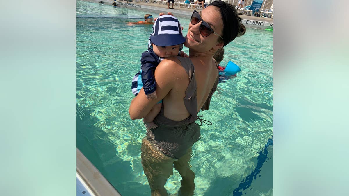 woman and son in bathing suits in pool
