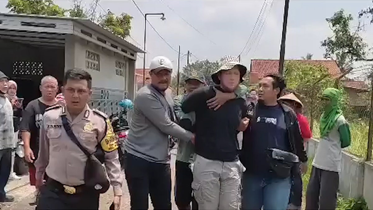 American man being arrested in Indonesia